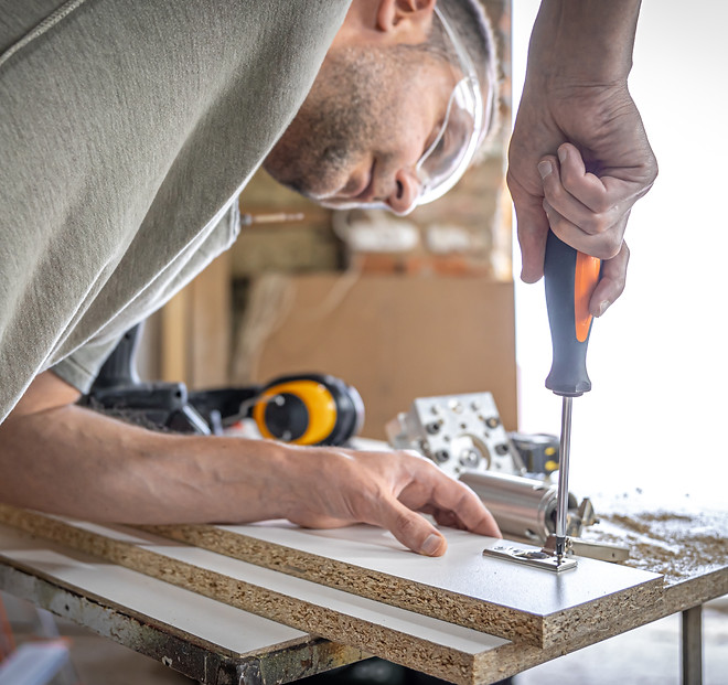 screwing-self-tapping-screw-into-metal-fastening-hole-wood-strip-using-screwdriver-work-ca