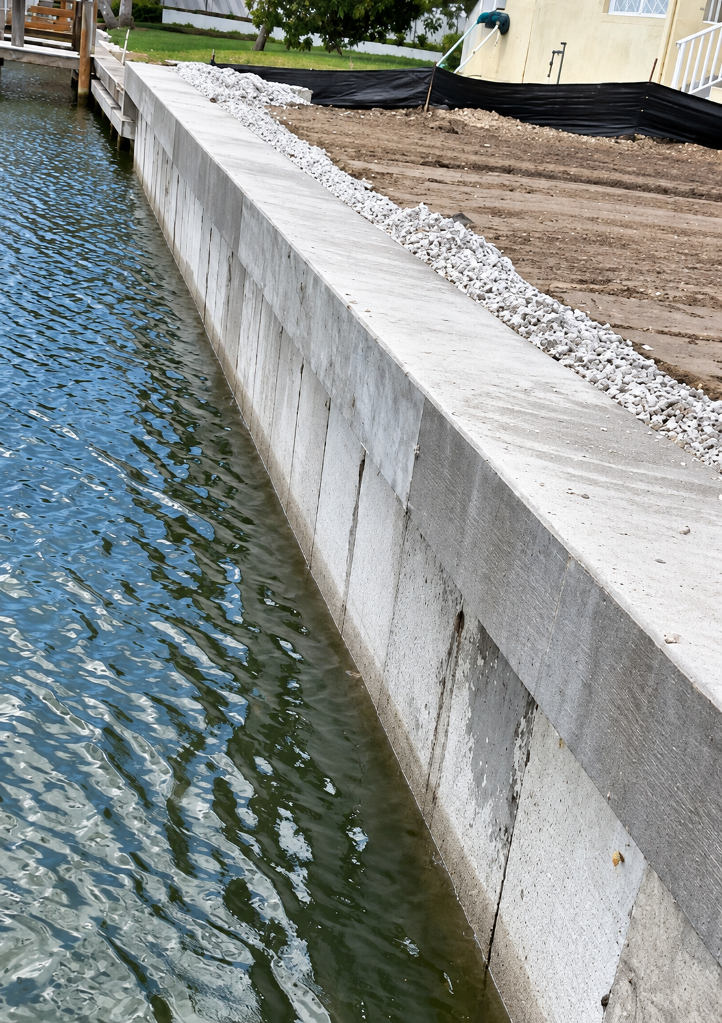 Concrete seawall along a waterfront property, built by Coastal DCS
