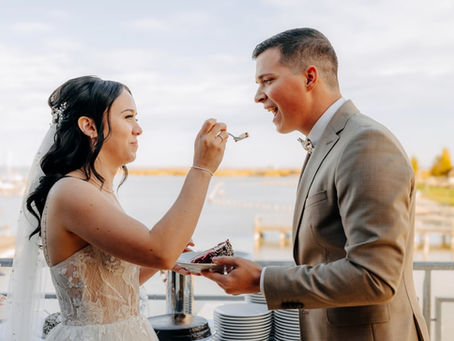 A happy wedding couple enjoying the cake