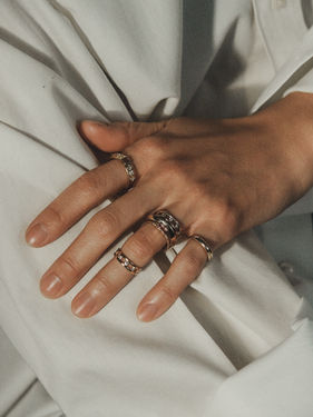 Cinematic photograph of Bruce rings on model’s fingers
