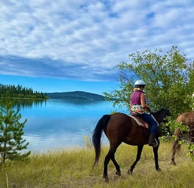 horseback rider by a lake