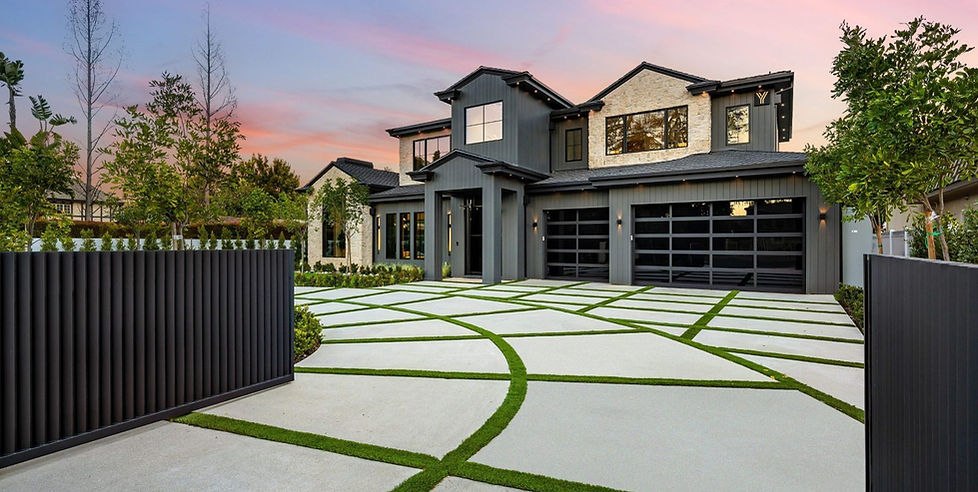 Contemporary two story home exterior with modern landscaping and geometric driveway design