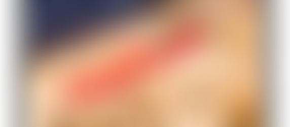 Rising red arrow over wooden houses symbolizing increased home value and real estate investment growth.