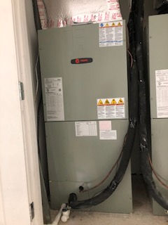 Residential HVAC air handler unit installation inside home utility closet