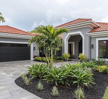 Front yard with stone walkway, plants, and modern landscaping.
