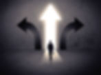A businessman in doubt, having to choose between three different choices indicated by arrows pointin