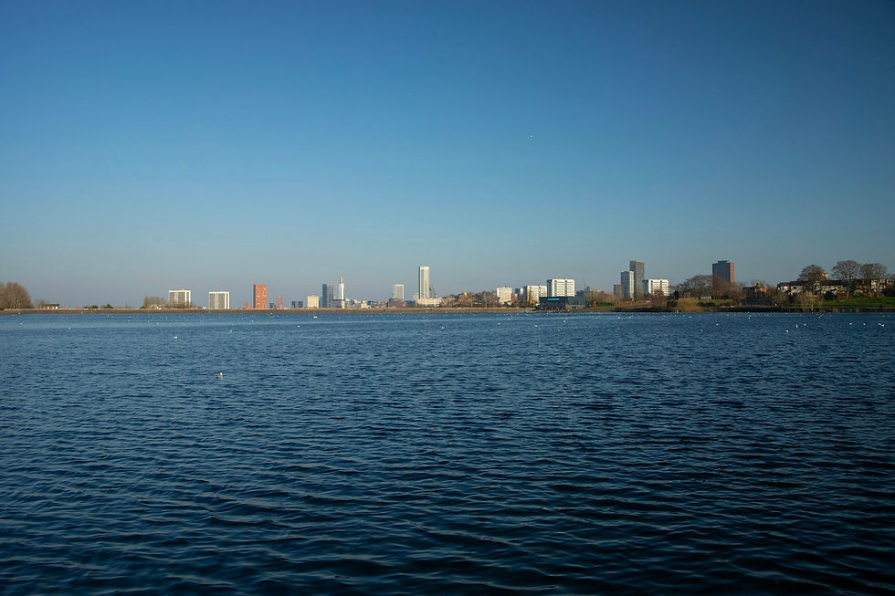 Birmingham skyline viewed across Edgbaston Reservoir on a clear day