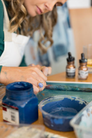 Artist in studio working on an art commission