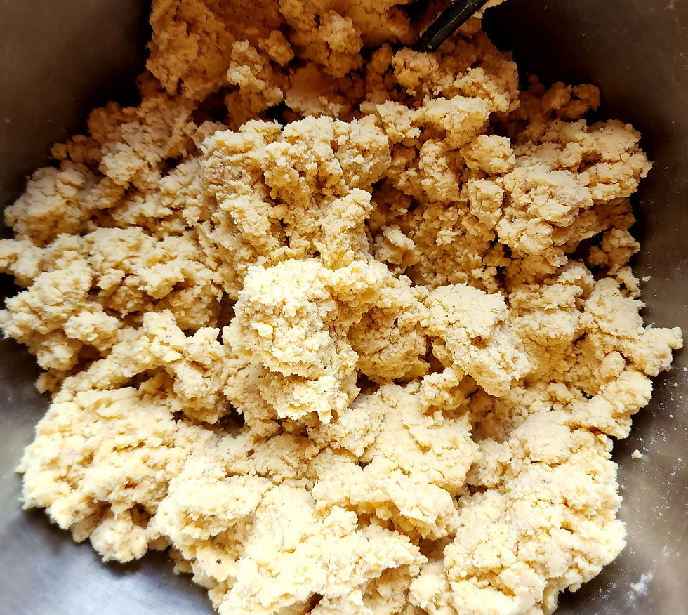 This is the stage where you stop adding water. It still looks crumbly, but when you squeeze it, it comes together.