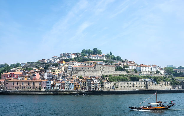 boat on water near city buildings during