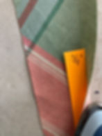 Iron on plaid green and red fabric with an orange note marked "3/4"." Beige background adds a neutral contrast.