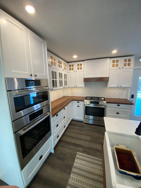 White kitchen with wood countertop and island