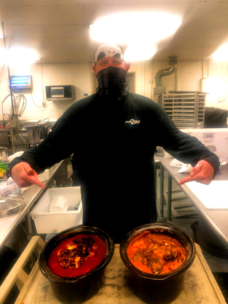 Kook in the kitchen with finished pork butts for Pork Green Chile and Street Pastor
