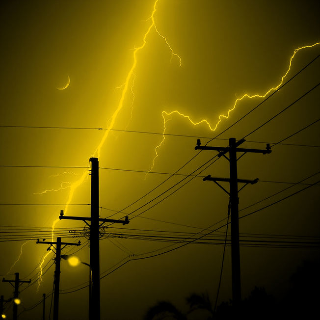 Lightning strikes near power lines during nighttime storm