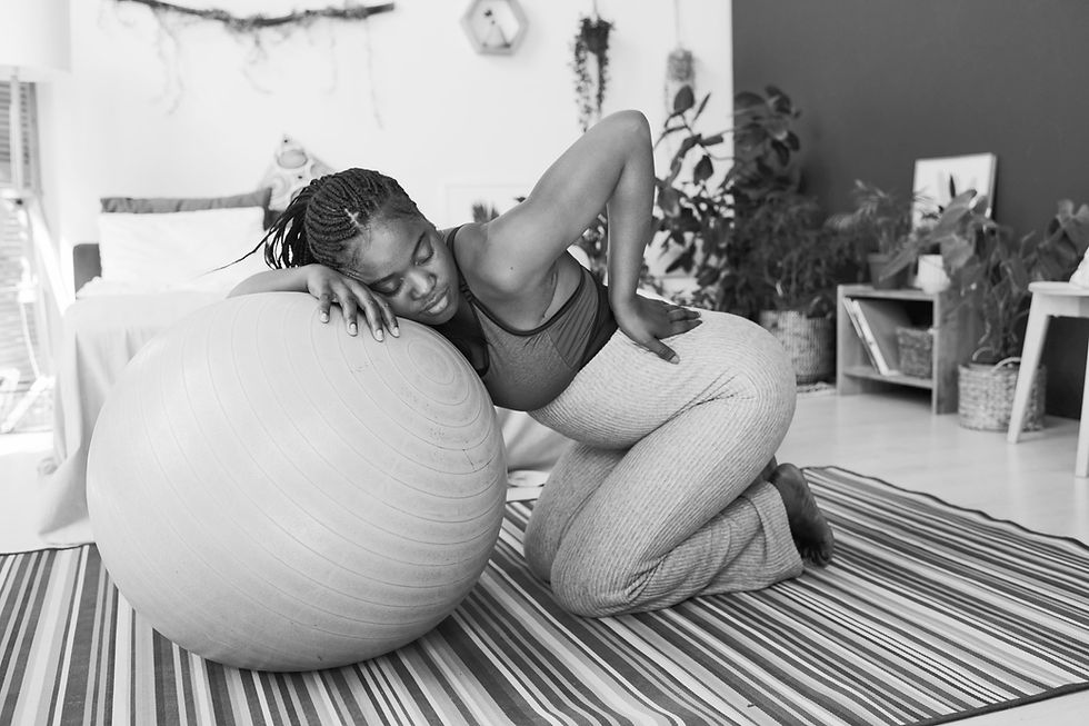 Woman stretching on birthing ball for labor prep