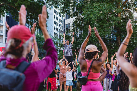 Troy Feldman leads the crowd during Svāha on the Land! at Jamii’s Joy in the Park on The Esplanade in David Crombie Park on The Esplanade in Toronto.