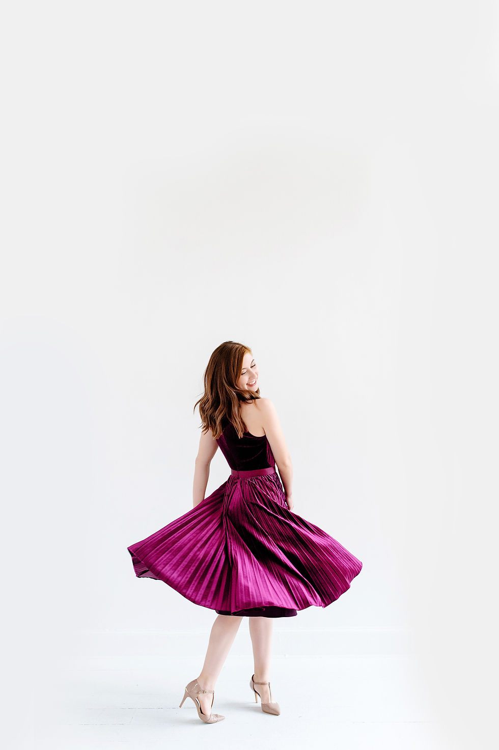 natural light studio headshot session of dancer swinging skirt