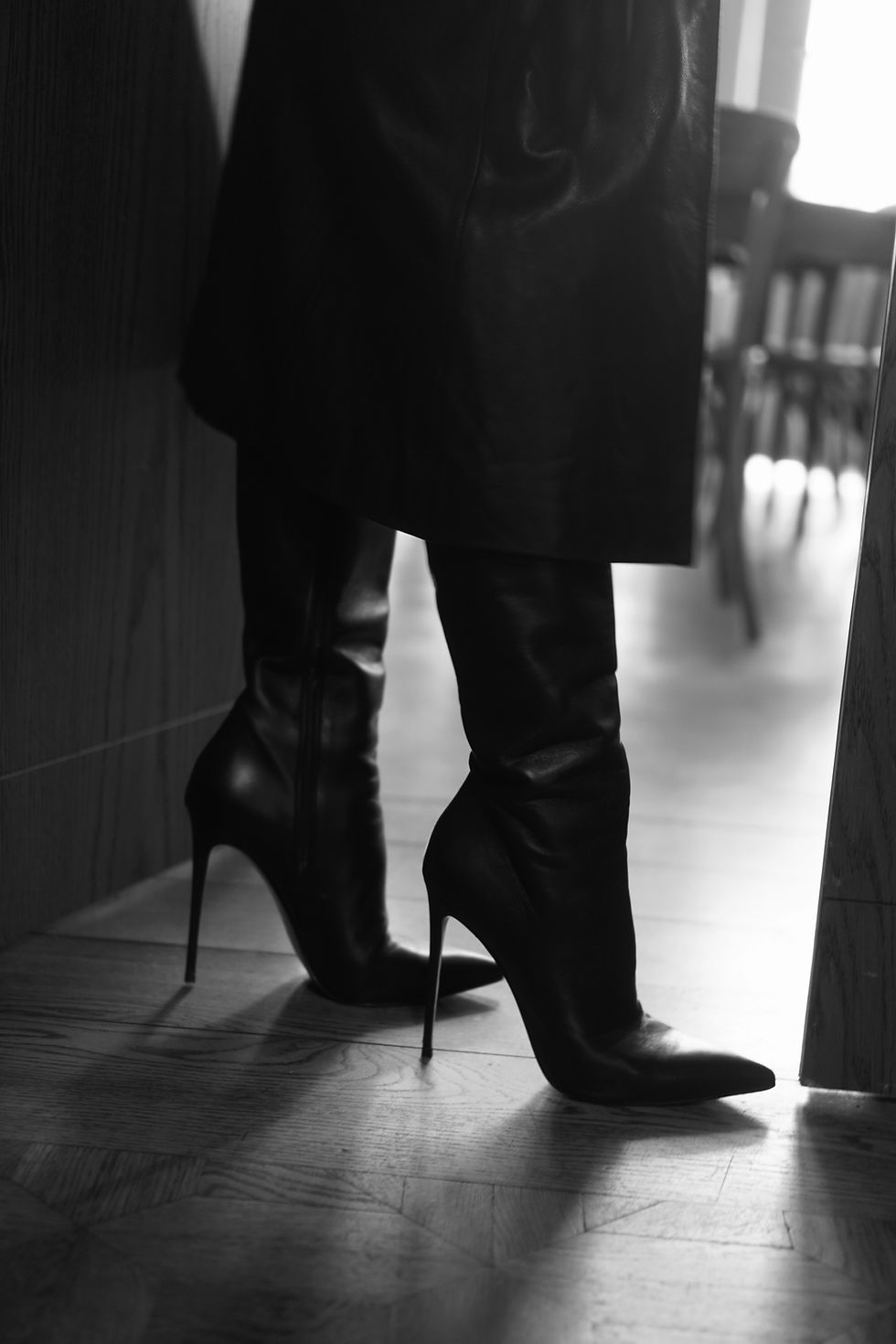 Mistress Deva Venera in leather boots, black-and-white photography