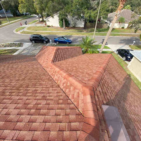 Top view of a suburban street with a car parked in front of a house