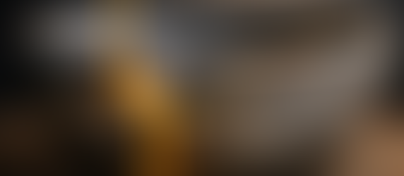 A close‑up of a dark, cracked ceramic bowl being repaired with molten gold. A thin stream of glowing liquid gold pours into the jagged fissure, filling it with light and creating a radiant golden seam — symbolizing kintsugi healing, restoration, and the beauty of mending broken places.