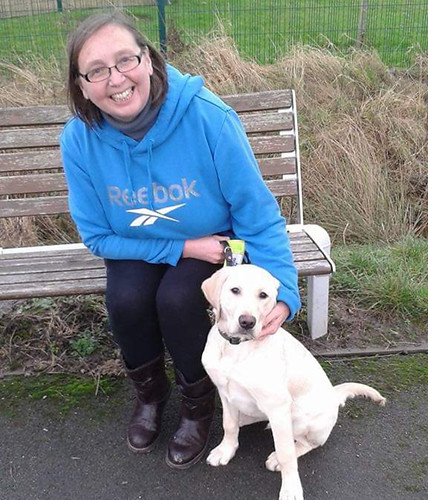 Cindy sat on a bench with York our lovely first ex Guide Dog