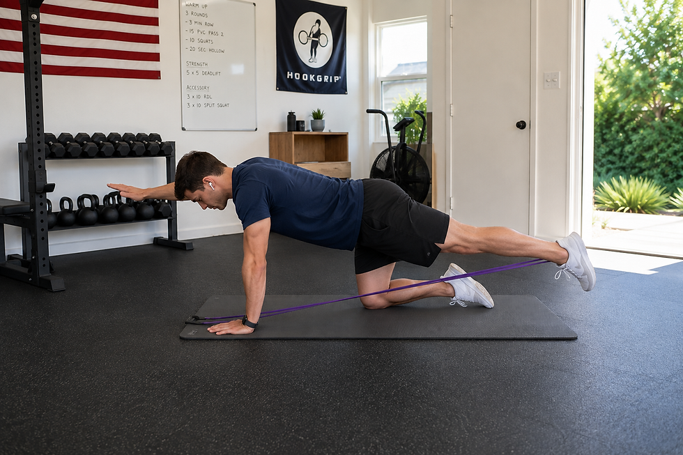 Man performing a banded bird dog exercise for core stability, coordination, and movement control.