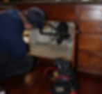 Plumber inspecting sink drain pipe