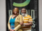 Couple smiling by banner saying Beyond The Walls Church, Beyond The Walls