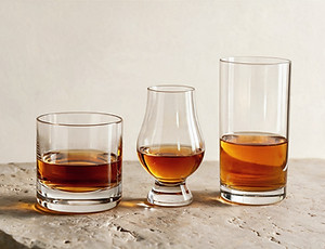Filled whiskey glasses representing different glass types and serving styles