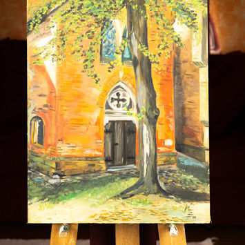 Gemälde einer Backsteinkirche auf einer Staffelei