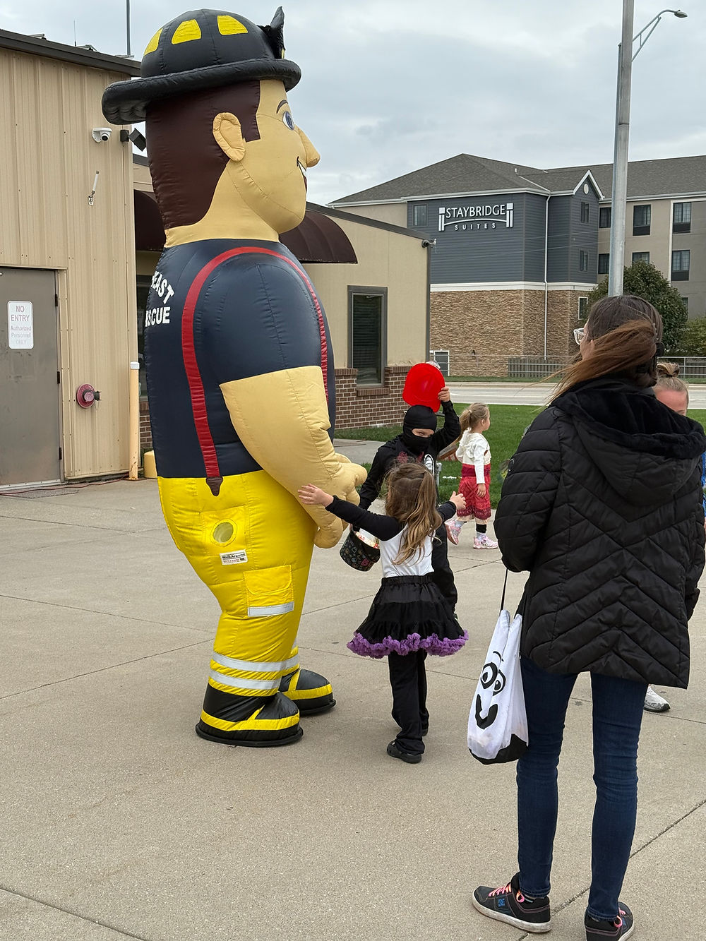 Children with inflatable firefighter mascot at Fire Department