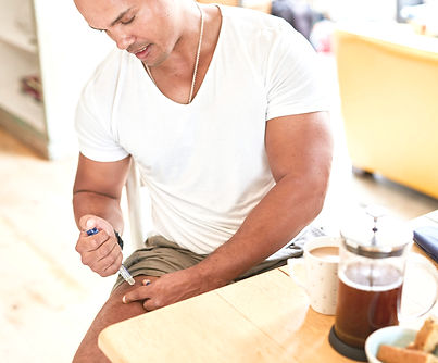 A man injects himself with medication._edited.jpg