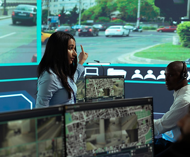 indian-woman-team-leader-guides-her-staff-monitor-surveillance-footage (1).jpg
