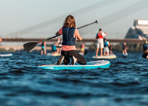 female-rowing-with-sup-paddle-boards-along-river.jpg