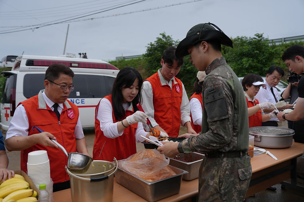 A Salvation Army team serves food to military personnel supporting the relief effort.