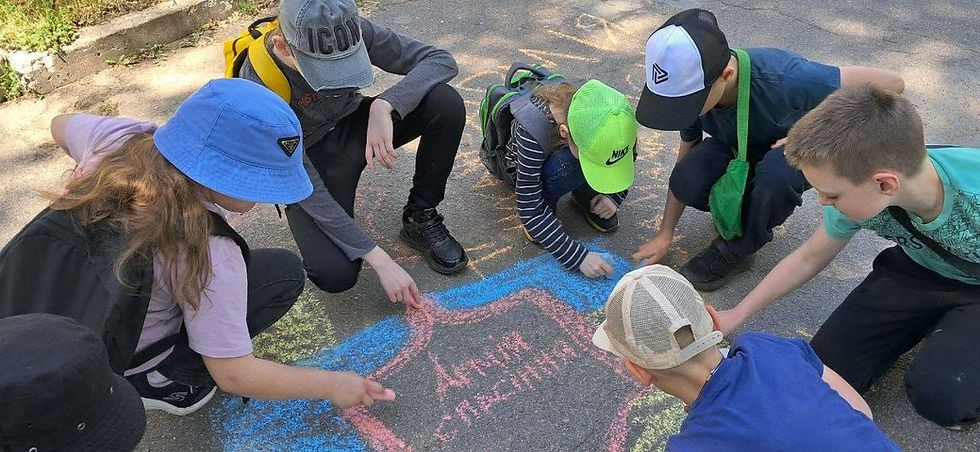 Children draw The Salvation Army shield and Ukrainian flag before drones forces them inside.