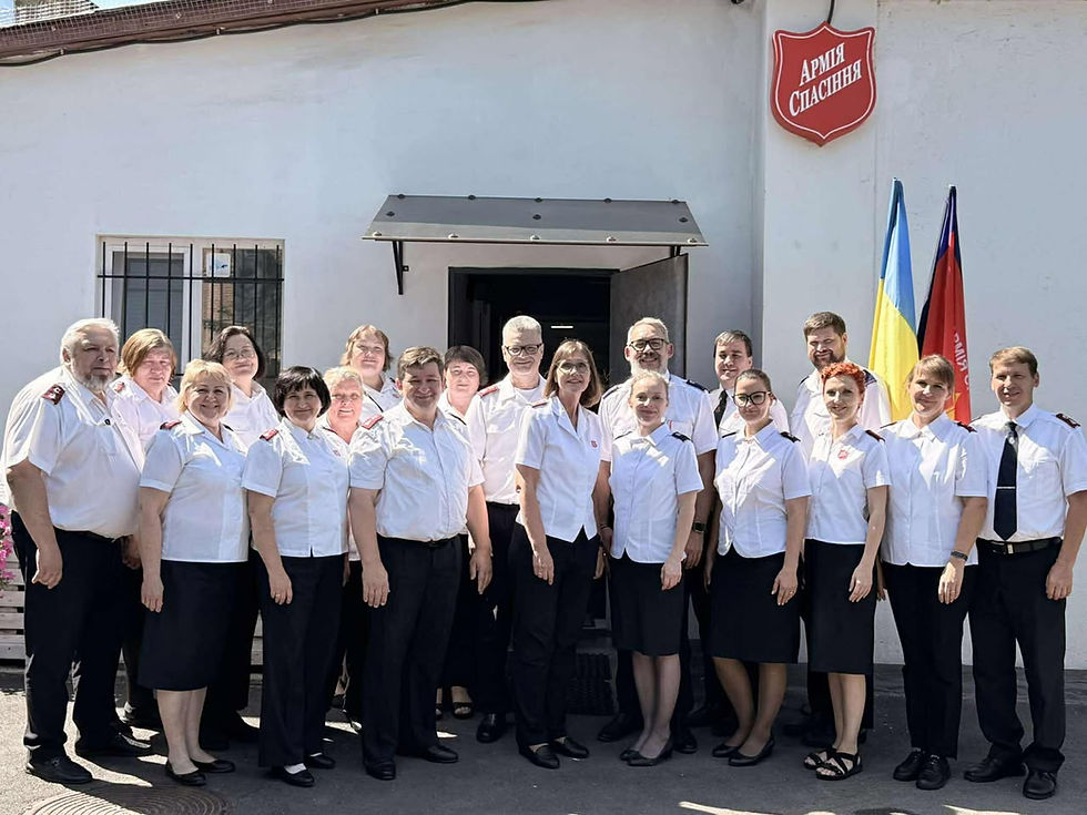 Colonels Joao Paolo and Karin Ramos (centre) with officers of the Ukraine Division and Major Andrei Iniutocichin, Territorial Assistant Chief Secretary (second from right, back row).