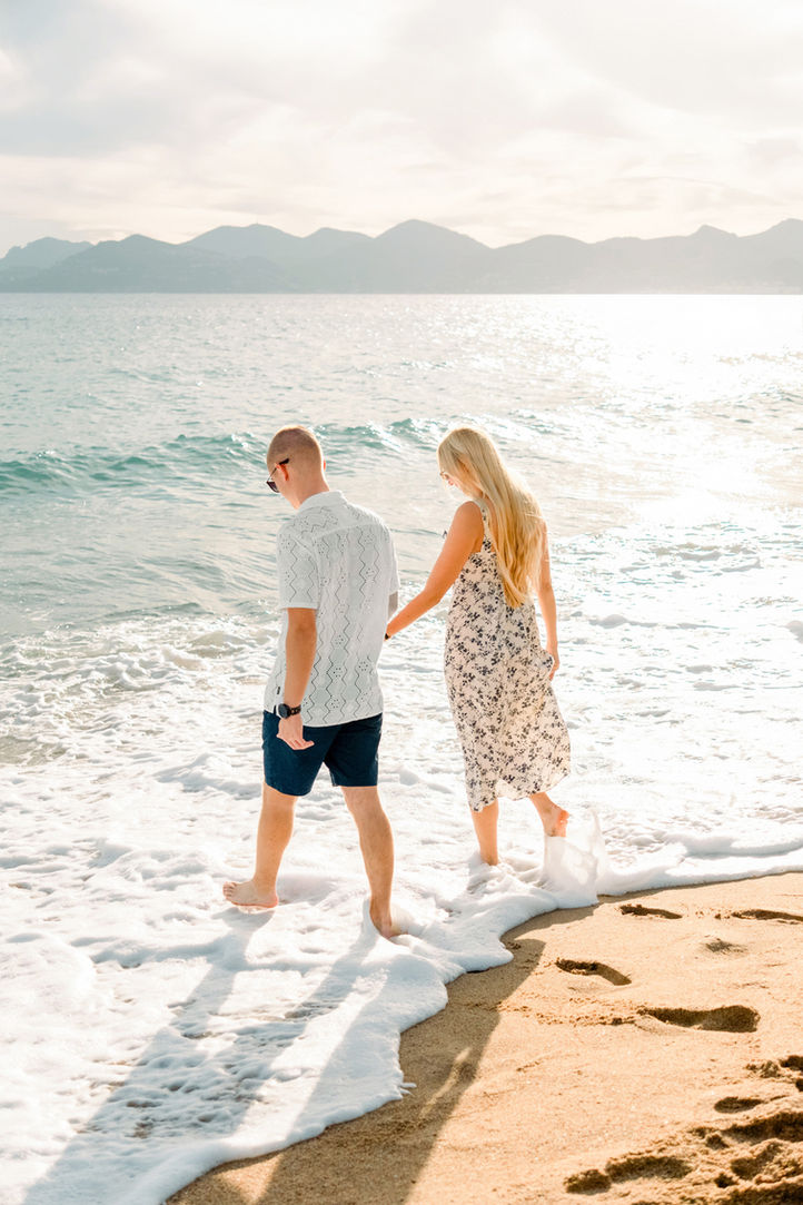 A couple enjoying a sunset walk by the beach in Cannes, photographed by The Bercans.