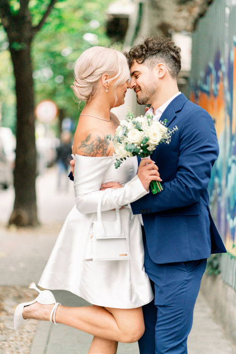 Bride and her groom, smiling together and embracing before their civil wedding ceremony in Bucharest.