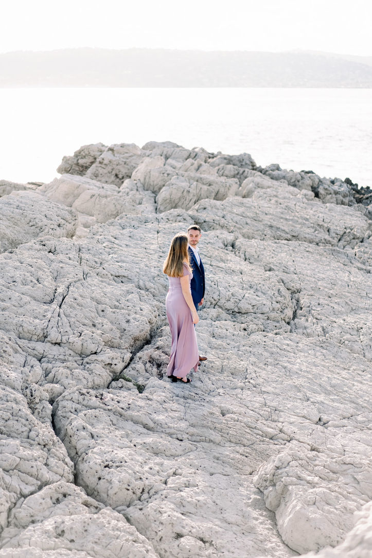 Couple sharing a sweet moment on the rugged coastline of the South of France.