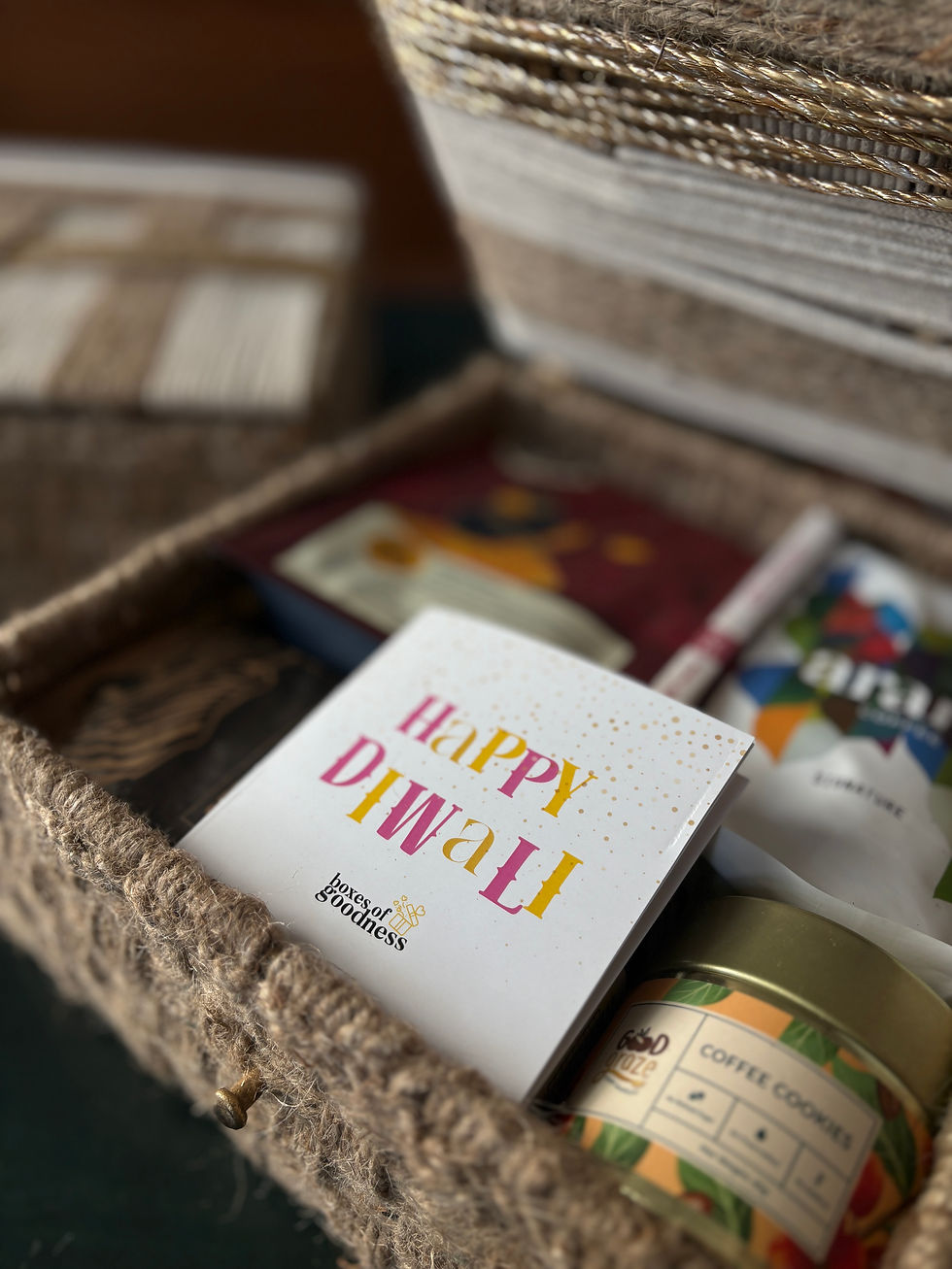 a gift opened showing contents, with a card that says happy diwali