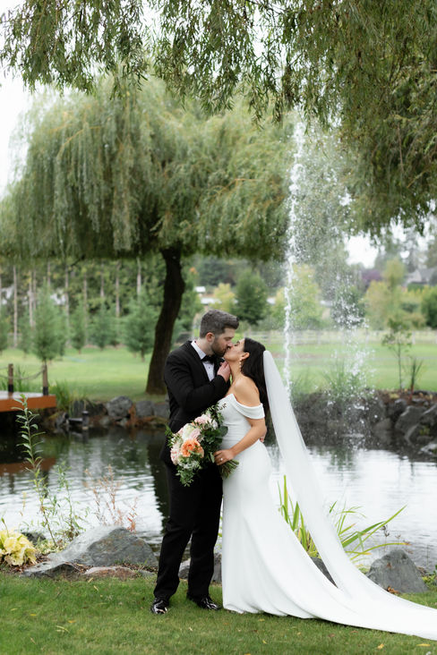 Cristina & Justin's Elegant Fairy Tale Garden Wedding Bridal Photos.  Surrounded by flowing flowers, trailing vines and gardens. Summer flowers in whites, mauve, pinks and blushes with greenery and grasses.  The tables were done in white linens, white chargers, gold flatware, rose napkins and wood chairs. The wedding stationery was white cotton hand torn menus and place cards with rose ribbon.