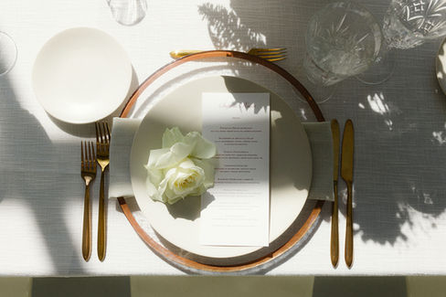 Melina & Michael's Elegant, Romantic Custom Wedding Menus. Soft White and Ivories with hints of Blush Pink. Gold Flatware, Crystal Stemware, White Linens and Chairs with Romantic Florals. White and Blush Pink Custom Wedding Stationery.