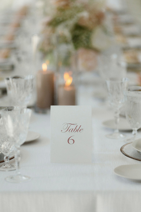 Melina & Michael's wedding exuded elegance and romance, featuring a palette of soft whites, ivory, and gentle blush pink. The delicate tables adorned with gold and crystal stemware, paired with pristine white linens and chairs, created a modern yet regal atmosphere, perfect for their day. Every detail was thoughtfully curated to reflect their love, making it an unforgettable celebration.
Introducing our elegant and timeless custom wedding signage, designed to elevate your special day. From beautiful table numbers to romantic menus, each piece is crafted to complement your unique vision. Let us help you create a memorable atmosphere that reflects your love story and adds a touch of sophistication to your celebration.