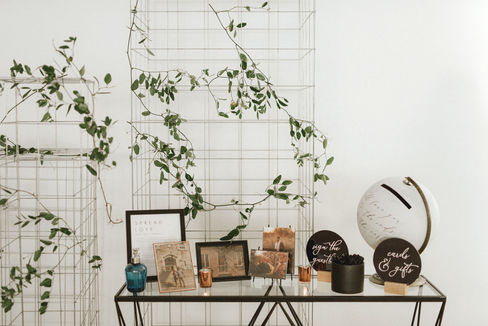 Step into the captivating world of L&S's wedding, where elegance seamlessly intertwined with simplicity, all set against the stunning
backdrop of the ocean. The bride truly stole the show, donning exquisite pink lace shoes and delicate crystal flowers in her hair, embodying the essence of romance. The ceremony itself exuded charm, beautifully by the dramatic contrast of dark colours blended
harmoniously with soft whites, creating a perfect romantic ambience for their special day. Each table was meticulously designed to a bold statement, showcasing luxurious black linens, elegant black charger plates, gleaming gold flatware, and striking black glassware, all contributing to the sophisticated aesthetic that the bride & groom envisioned. The floral were nothing short of mesmerizing, featuring deep, moody tones with a stunningly romantic touch to the overall atmosphere, making it a day to remember.
We created stunning custom wedding invitations in full colour with a luxurious soft touch and exquisite digital gold foil accents. Our one-of-a-kind wedding signage in dark, moody colours made a bold statement, adding elegance to their special day. Delighted guests had round custom wedding menus with amazing digital gold print that sparkled beautifully on each table.
Decorate your wedding with unique designs that reflect your personal style. From invitations to decor, our creations will make your day unforgettable. Celebrate love in a way that’s uniquely yours with our elegant creations.