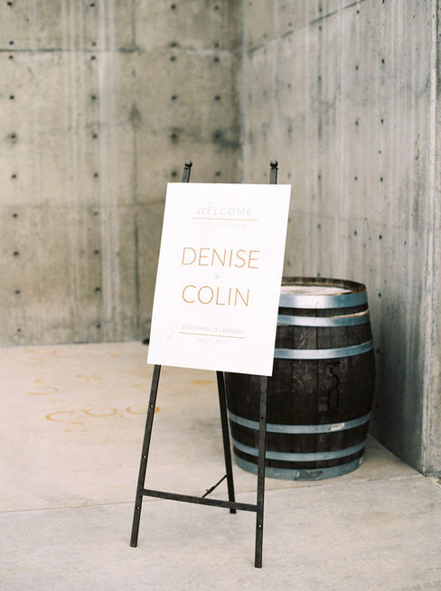 Celebrate the elegance of Denise & Colin's winery wedding, where white florals, black accents, gold details, and a stunning marble finish came in perfect harmony. The reception featured a breathtaking marble wall adorned with delicate white blooms, creating a dreamy backdrop. Dive into the details that made their day unforgettable and discover how this couple infused their unique style into every aspect of their celebration.
D&C elevated their special occasion with our custom square invitations, elegantly printed with stunning rose gold foil. They complemented their wedding celebration with our unique black cotton menus, featuring crisp ink and adorned with a custom gold wax seal for
that perfect finishing. Make your event truly unforgettable with these exquisite details that reflect your personal style.