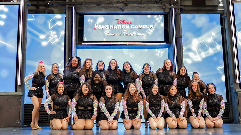 Adult dance group posing on the Disneyland stage in sequin costumes