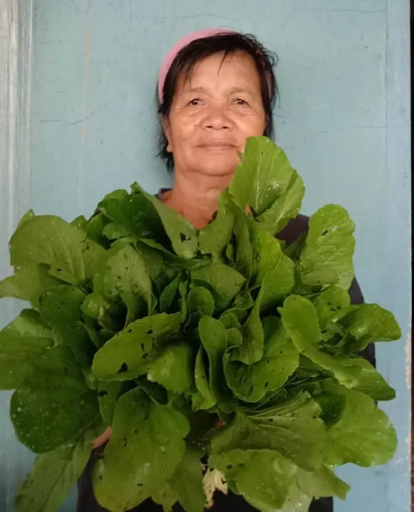 rural farmer with her freshly harvested self grown crops
