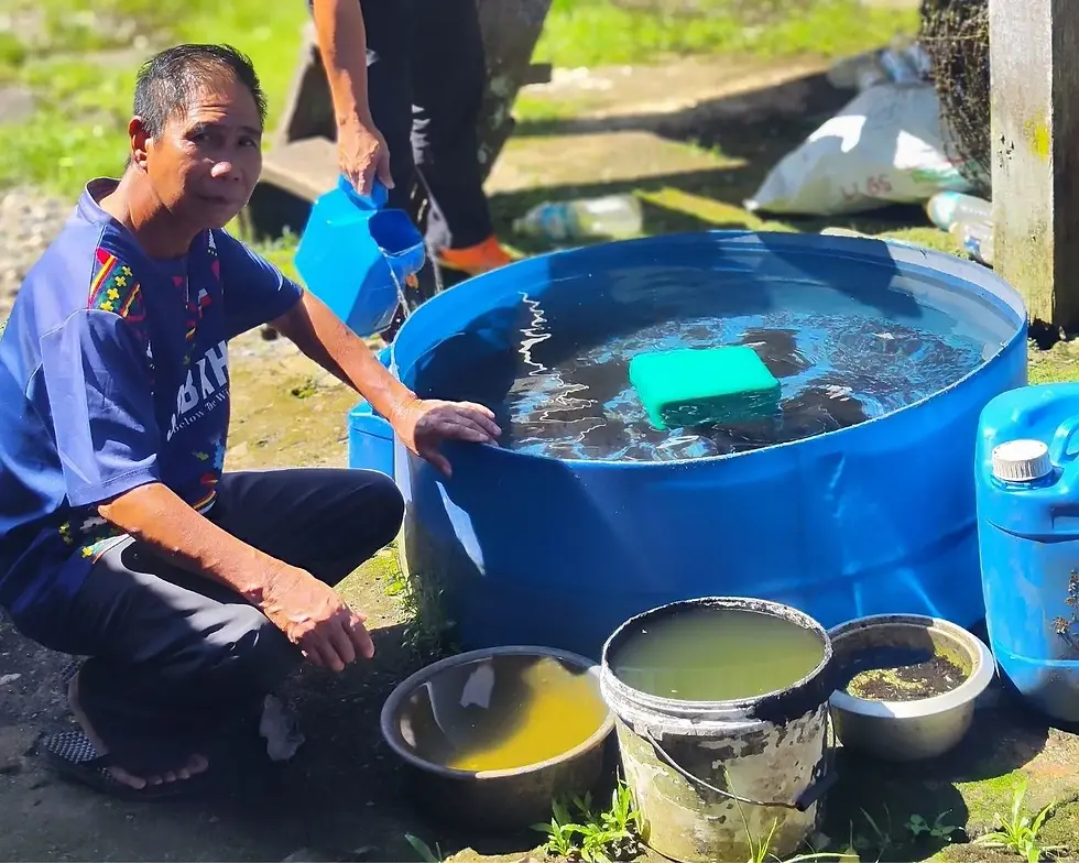 Villager and buckets of water collected for household usage