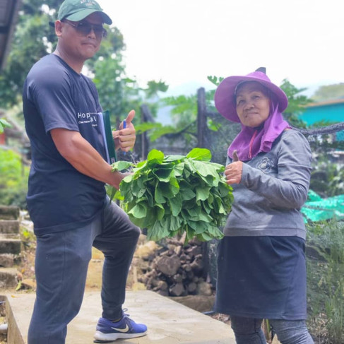 Efandi with one of the rural farmers and her harvested crop